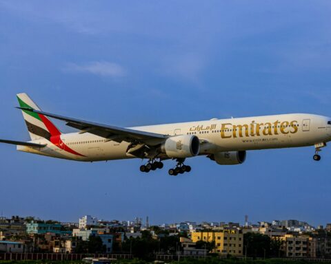 A large jetliner flying through a blue sky